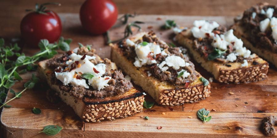 recipe image Bruschettas with Oregano, Olive Paste and Manouri Cheese