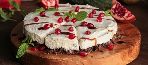 recipe image Festive cheesecake with pomegranate seeds and carob rusks